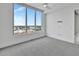 Bright bedroom with a ceiling fan and a large window view at 111 S Pineapple Ave # 1018, Sarasota, FL 34236