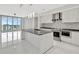 Sleek, modern kitchen with stainless steel appliances, waterfall island and city views at 111 S Pineapple Ave # 1018, Sarasota, FL 34236