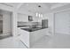 Modern kitchen with stainless steel appliances, large island, and open floor plan in condominium at 111 S Pineapple Ave # 1018, Sarasota, FL 34236
