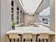 Contemporary kitchenette with a quartz countertop, modern cabinetry, and sleek seating arrangements at 111 S Pineapple Ave # 1018, Sarasota, FL 34236