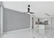 Open concept living room features tile floors, a ceiling fan, and an open kitchen at 111 S Pineapple Ave # 1018, Sarasota, FL 34236