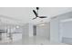 Open concept living room features tile floors, a ceiling fan, and an open kitchen at 111 S Pineapple Ave # 1018, Sarasota, FL 34236
