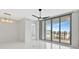 Bright living room with modern lighting, tile floors, and sliding doors to a balcony at 111 S Pineapple Ave # 1018, Sarasota, FL 34236