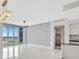 Living area with tile floors, access to a balcony, ceiling fan, and an open kitchen at 111 S Pineapple Ave # 1018, Sarasota, FL 34236