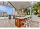 Charming outdoor kitchen with a built-in grill, bar seating, and picturesque city views at 111 S Pineapple Ave # 1018, Sarasota, FL 34236
