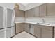 The pantry has modern cabinets, quartz countertops, and stainless steel appliances at 111 S Pineapple Ave # 1018, Sarasota, FL 34236
