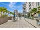Relaxing patio area with comfortable seating, lush palm trees, and stylish outdoor dining spaces at 111 S Pineapple Ave # 1018, Sarasota, FL 34236