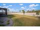 Fenced backyard with grass and small trees at 11160 Fieldstone Dr, Palmetto, FL 34221