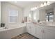 Elegant bathroom with double vanity, soaking tub, and separate shower at 11160 Fieldstone Dr, Palmetto, FL 34221