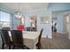 Bright dining room with a large table, chandelier, and view into the kitchen at 11160 Fieldstone Dr, Palmetto, FL 34221