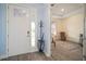 Bright entryway with tile flooring, coat rack, and view into living room at 11160 Fieldstone Dr, Palmetto, FL 34221