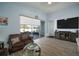 Comfortable living room with large TV and view of backyard patio at 11160 Fieldstone Dr, Palmetto, FL 34221