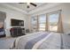 Main bedroom with large windows, TV and backyard views at 11160 Fieldstone Dr, Palmetto, FL 34221