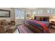 Main bedroom with plush bedding, large window, and comfortable armchair at 13789 Old Creek Ct, Parrish, FL 34219