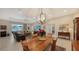 Bright dining room with wood table and chairs, adjacent to kitchen at 13789 Old Creek Ct, Parrish, FL 34219