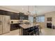 Spacious kitchen with dark cabinetry, granite countertops, and island at 13789 Old Creek Ct, Parrish, FL 34219