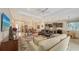 Spacious living room with ample seating and views into kitchen and dining area at 13789 Old Creek Ct, Parrish, FL 34219