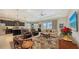 Living room with comfortable seating, a large TV, and a view of the backyard at 13789 Old Creek Ct, Parrish, FL 34219