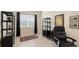 Home office features built-in shelving, window seating, and comfortable office chair at 13789 Old Creek Ct, Parrish, FL 34219