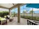 Relaxing screened porch overlooking a lake with wicker furniture at 13789 Old Creek Ct, Parrish, FL 34219