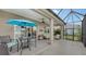 Covered patio with table and chairs, overlooking the lake at 13789 Old Creek Ct, Parrish, FL 34219