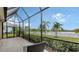Screened porch with lake view and wicker chair at 13789 Old Creek Ct, Parrish, FL 34219