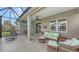 Spacious screened porch with wicker furniture and lake view at 13789 Old Creek Ct, Parrish, FL 34219