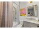 Modern bathroom with granite vanity, shower, and patterned curtain at 17424 Cresswind Ter, Bradenton, FL 34211