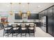 Modern kitchen with a large island, dark cabinetry, and quartz countertops at 17424 Cresswind Ter, Bradenton, FL 34211
