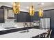 Modern kitchen with dark cabinetry, geometric backsplash and stainless steel appliances at 17424 Cresswind Ter, Bradenton, FL 34211