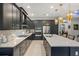 Modern kitchen with dark cabinetry, geometric backsplash, and a large island at 17424 Cresswind Ter, Bradenton, FL 34211