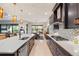 Spacious kitchen with dark cabinetry, geometric backsplash, and large island at 17424 Cresswind Ter, Bradenton, FL 34211