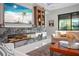 Elegant living room with a modern fireplace and built-in shelving at 17424 Cresswind Ter, Bradenton, FL 34211