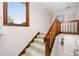 Indoor staircase with wood railings and carpeted steps leading to upper level at 6012 Courtside Dr # 1, Bradenton, FL 34210