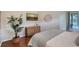 Bright bedroom with large window and dresser, offering access to a patio at 6476 Royal Tern Cir, Lakewood Ranch, FL 34202