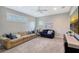 Spacious bonus room features a large TV, comfortable seating, and plenty of natural light at 6476 Royal Tern Cir, Lakewood Ranch, FL 34202