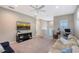 Open bonus room with TV, seating area, and a view of the upper hallway at 6476 Royal Tern Cir, Lakewood Ranch, FL 34202