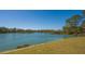 Scenic lakefront property with lush green landscape and mature trees at 6476 Royal Tern Cir, Lakewood Ranch, FL 34202