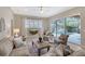 Living area with a view of the pool through sliding glass doors at 6476 Royal Tern Cir, Lakewood Ranch, FL 34202