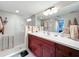 Bathroom features double vanity, large mirror, and a walk-in shower at 6609 Stone River Rd # 104, Bradenton, FL 34203