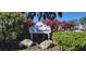 The Verandas community sign, nicely landscaped with lush greenery at 6609 Stone River Rd # 104, Bradenton, FL 34203