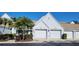 Attractive exterior featuring two-car garage and landscaping at 6609 Stone River Rd # 104, Bradenton, FL 34203