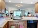 Kitchen boasts granite countertops and a breakfast bar overlooking the living room at 6609 Stone River Rd # 104, Bradenton, FL 34203