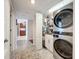 Stackable washer and dryer in a well-lit laundry closet at 6609 Stone River Rd # 104, Bradenton, FL 34203