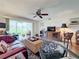 Bright living room with comfy seating, large windows, and access to a relaxing patio at 6609 Stone River Rd # 104, Bradenton, FL 34203