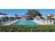 Community pool with surrounding lounge chairs and landscaping at 6609 Stone River Rd # 104, Bradenton, FL 34203