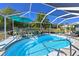 Inviting screened-in pool with a tropical umbrella, perfect for relaxing and enjoying the Florida sunshine at 6629 Pleasant Hill Rd, Bradenton, FL 34203