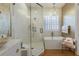 Spa-like bathroom with a soaking tub, walk-in shower, and gold accents at 1923 Hibiscus St, Sarasota, FL 34239