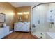 Elegant bathroom with a double vanity, large shower, and gold wallpaper at 1923 Hibiscus St, Sarasota, FL 34239