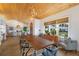 Elegant dining room with a long live-edge wood table and wood floors at 1923 Hibiscus St, Sarasota, FL 34239